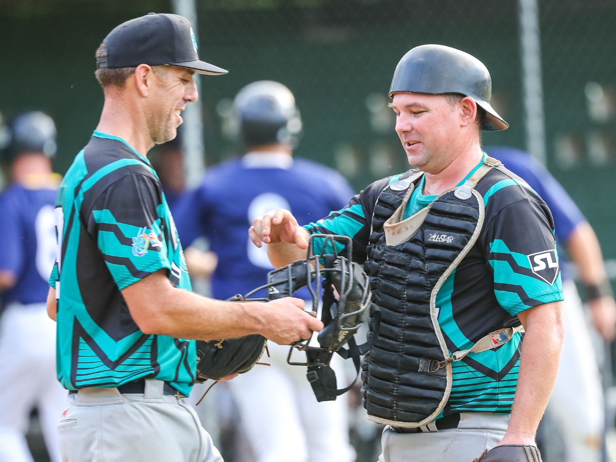 Masters team mate handing over catcher mask