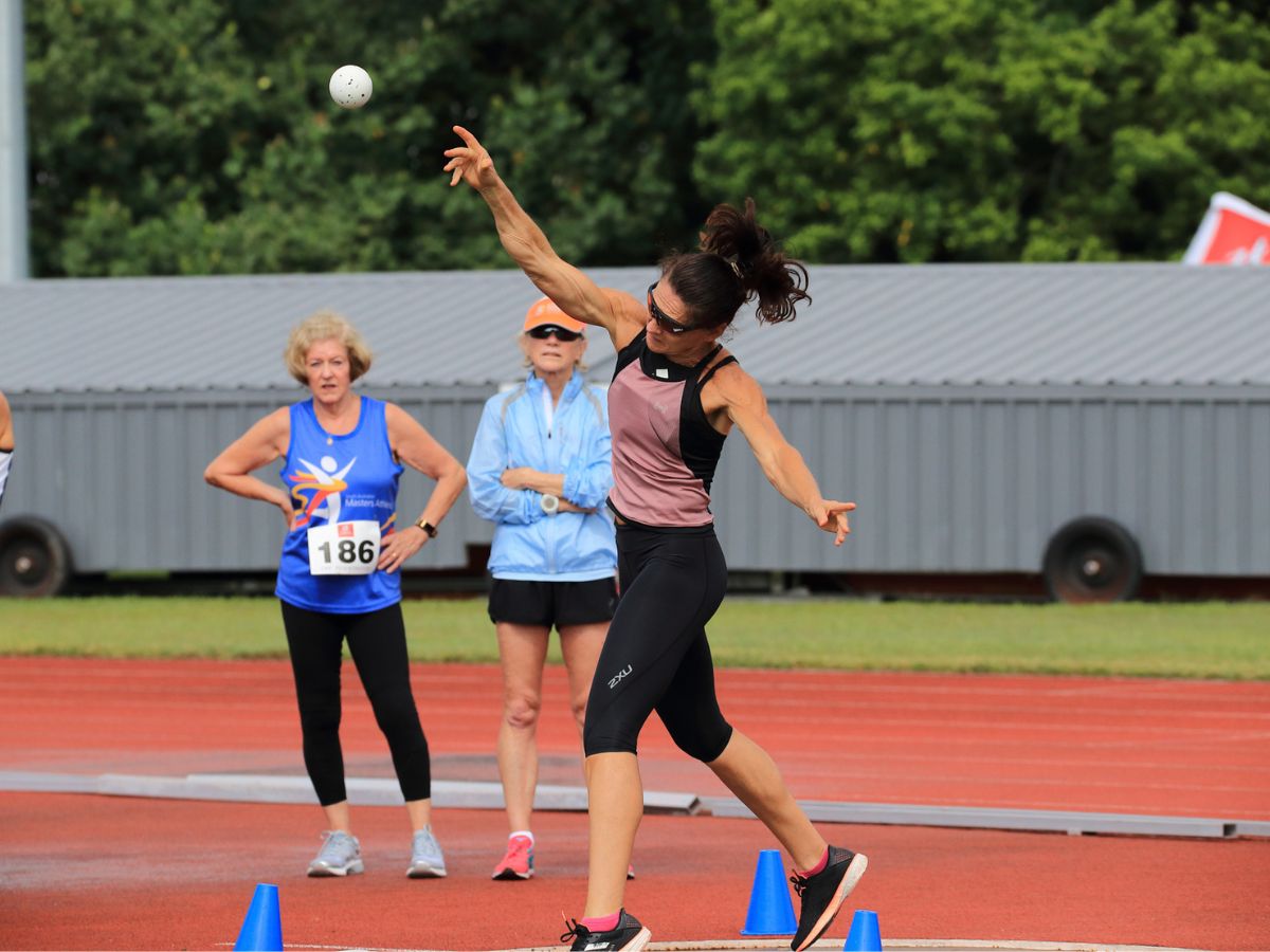 Masters woman throwing shot put