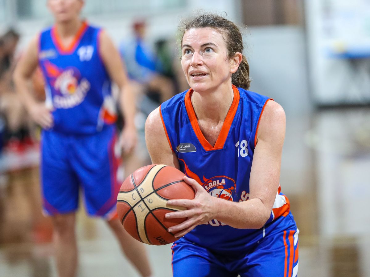 Masters woman shooting basketball