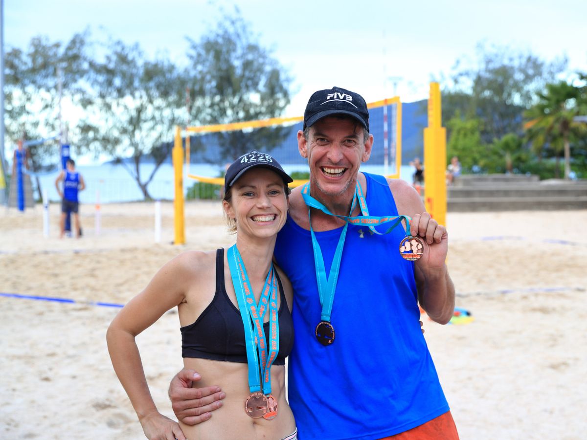 Master beach volleyball team holding medals