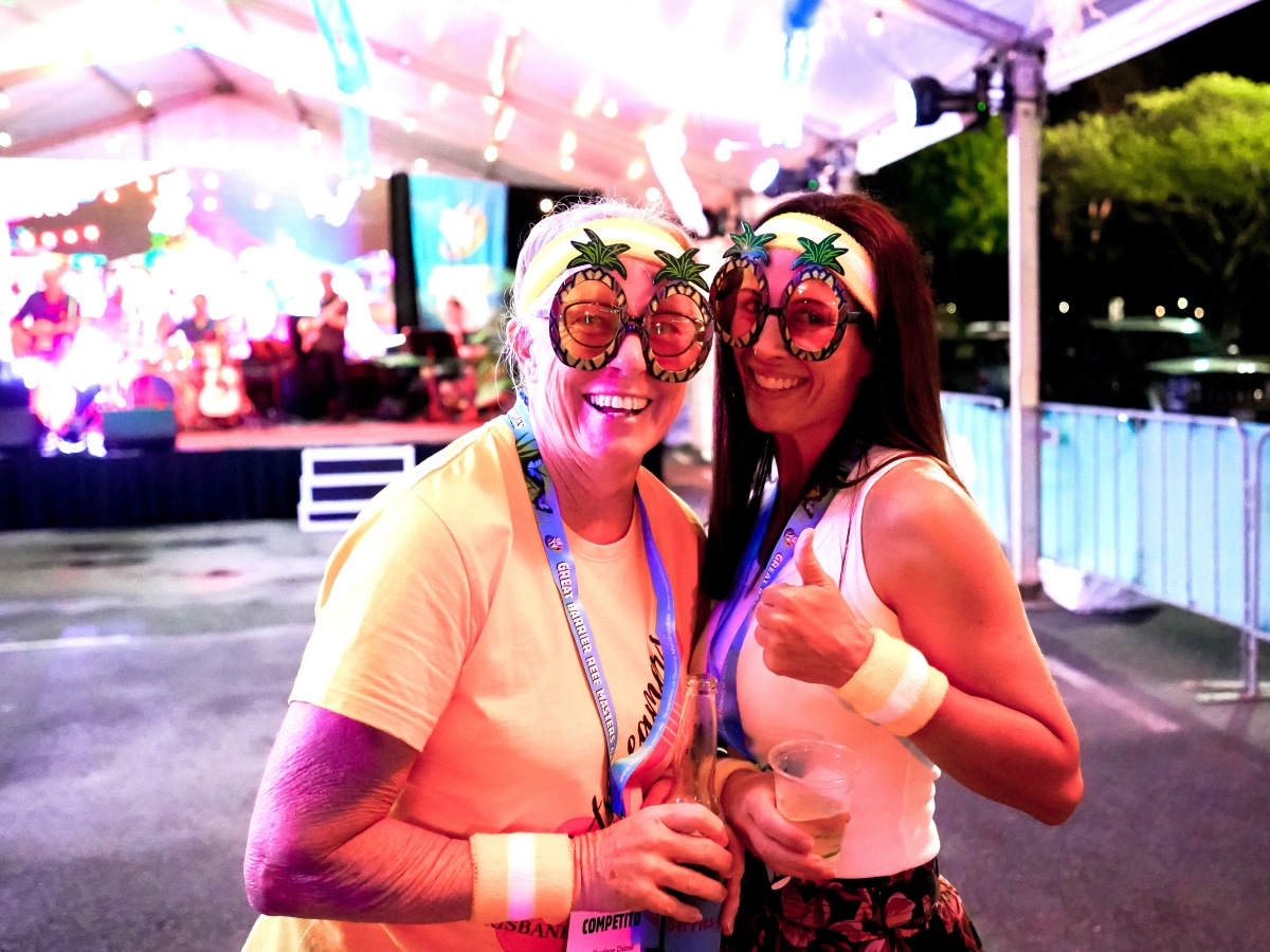  Two women posing for a photo together, smiling at the opening party event