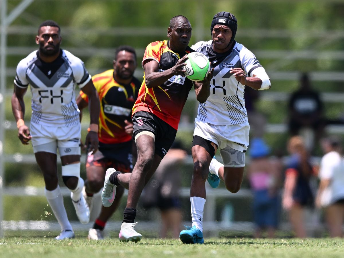 Rugby league player being tackled by the opposing team