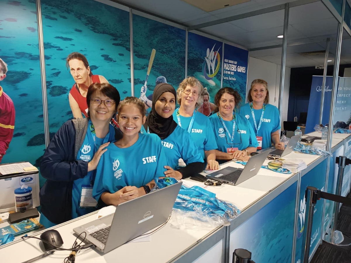 Group of volunteers smiling and posing for a photo