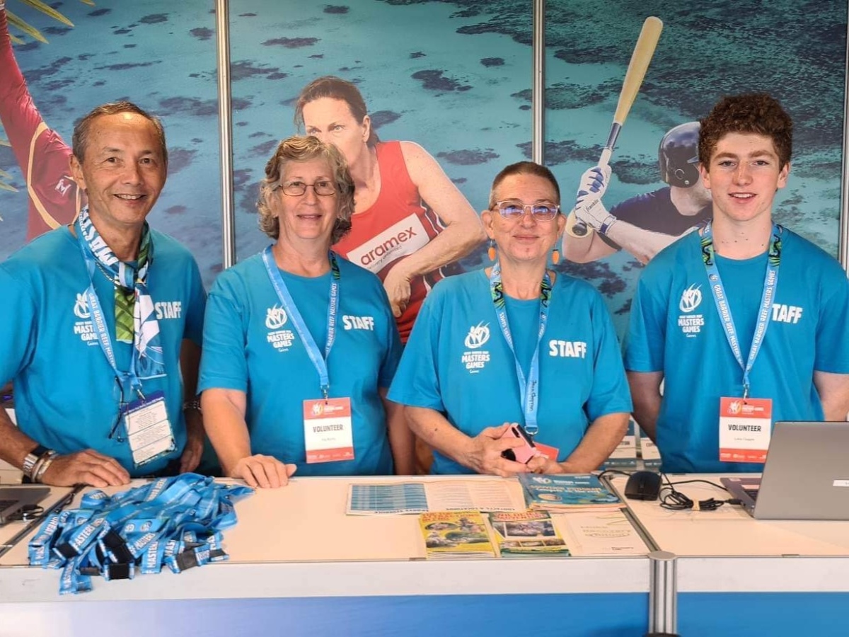 Group of volunteers smiling and posing for a photo