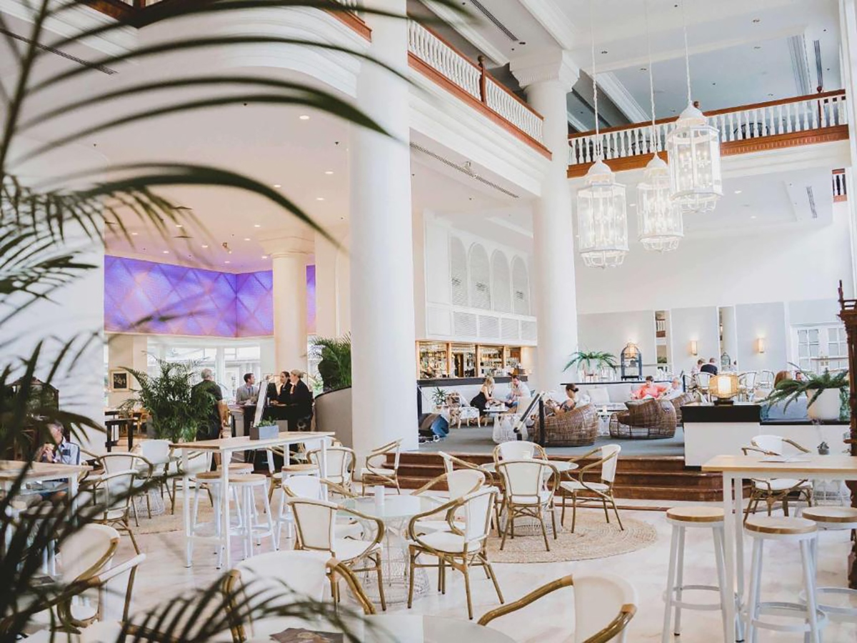 Foyer of the Pullman International hotel is depicted, showcasing a spacious and elegant entrance area